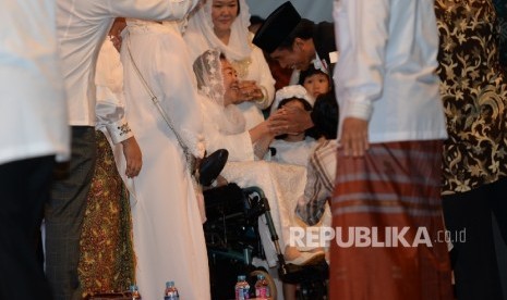 Presiden Joko Widodo diterima oleh Istri Gus Dur Shinta Nuriyah saat Haul Gus Dur ke-7 di Jakarta, Jumat (23/12). Pada Haul ke-7 Gus Dur ini mengangkat tema Menebar Damai Menuai Rahmat. 