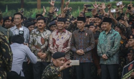 Presiden Joko Widodo (dua kiri) didampingi Menpora Imam Nahrawi (kanan) Menko Polhukam Wiranto (tengah) Panglima TNI Marsekal Hadi Tjahjanto (dua kiri) dan Gubernur DIY Sri Sultan HB X (kiri) berfoto bersama pemuda Kokam dan GP Ansor saat Apel Kebangsaan Pemuda Islam Indonesia di pelataran Candi Prambanan, Sleman, DI Yogyakarta, Sabtu (16/12). Apel kebangsaan yang diikuti 20.000 pemuda muslim dari Kokam dan GP Ansor ini untuk menyampaikan pesan merawat kebinekaan dan mensyukuri perbedaan dalam menegakkan NKRI. 