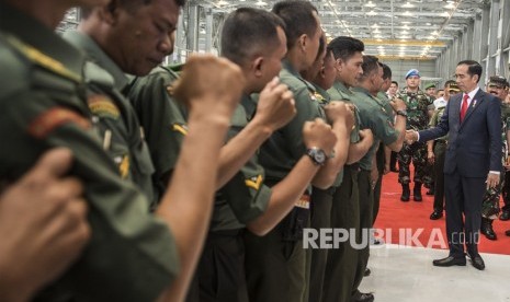 Presiden Joko Widodo (kanan) berjabat tangan dengan Bintara Pembina Desa (Babinsa) seluruh Indonesia ketika menghadiri Apel Besar Babinsa di Hanggar KFX PT DI di Bandung, Jawa Barat, Selasa (17/7).