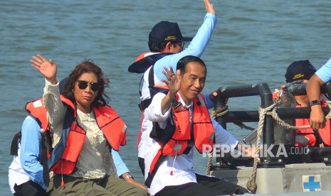 Presiden Joko Widodo (kanan) didampingi Menteri Kelautan dan Perikanan Susi Pudjiastuti (kiri) menumpang perahu karet untuk meninjau lokasi keramba ikan saat peresmian Keramba Jaring Apung atau offshore di Pelabuhan Pendaratan Ikan (PPI) Cikidang, Babakan, Kabupaten Pangandaran, Jawa Barat, Selasa (24/4).