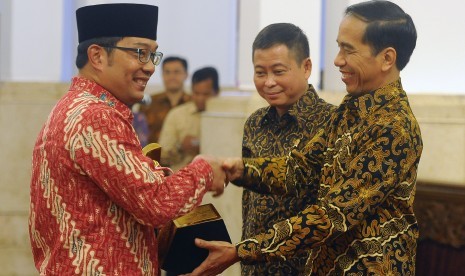 Presiden Joko Widodo (kanan) didampingi Menteri Perhubungan Ignasius Jonan (tengah) menyerahkan piala Wahana Tata Nugraha kepada Walikota Bandung Ridwan Kamil (kiri) di Istana Negara, Jakarta, Rabu (23/12). (Antara/Puspa Perwitasari)