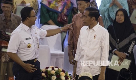 Presiden Joko Widodo (kedua kanan) berbincang dengan Gubernur DKI Jakarta Anies Baswedan (kiri) usai menyerahkan Sertifikat Tanah untuk Rakyat di Cengkareng, Jakarta, Rabu (9/1/2019). 