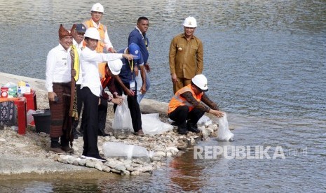 Presiden Joko Widodo (ketiga kiri) bersama Menteri Pekerjaan Umum dan Perumahan Rakyat (PUPR) Basuki Hadimuljono (kedua kiri), Mensesneg Pratikno (kiri), Gubernur NTT Viktor Laiskodat (kedua kanan), dan Bupati Belu Willy Lay (kiri) menebar benih ikan pada peresmian Bendungan Rotiklot di Belu, Atambua, NTT, Senin (20/5/2019). 