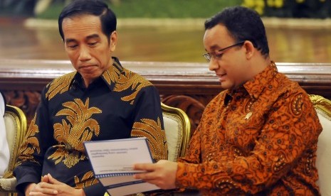 Presiden Joko Widodo (kiri) berdiskusi dengan Mendikbud Anies Baswedan (kanan) usai memberikan apresiasi kepada 503 Kepala Sekolah se-Indonesia dalam rangka Anugerah Integritas Ujian Nasional di Istana Negara, Jakarta, Senin (21/12). 