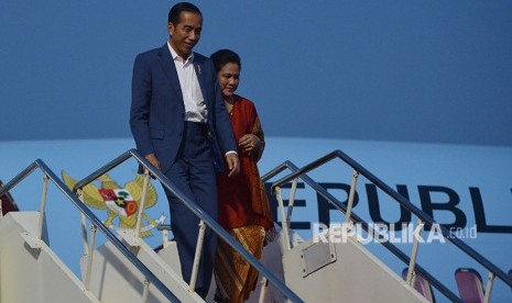 Presiden Joko Widodo (kiri) didampingi Ibu Negara Iriana Joko Widodo turun dari Pesawat Kepresidenan BBJ 2.