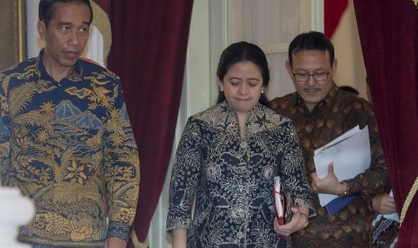 Presiden Joko Widodo (kiri) didampingi Menko PMK Puan Maharani (tengah) dan Dirut BPJS Kesehatan Fachmi Idris (kanan) bersiap memberikan keterangan pers di Istana Merdeka, Jakarta, Kamis (10/3). 