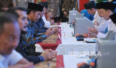 Presiden Joko Widodo membayar zakat penghasilan melalui Baznas di Istana Merdeka, Jakarta, Kamis (16/5).