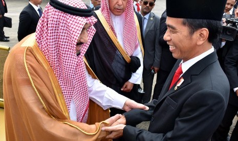 Presiden Joko Widodo menyambut Raja Arab Saudi Salman bin Abdulaziz Al-Saud (kiri) saat tiba di Bandara Halim Perdanakusuma, Jakarta, Rabu (1/3). 