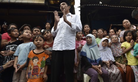 President Joko Widodo (central) was talking to residents after giving basic necessities parcel at Duri Kepa, Jakarta, Thursday (June 22).