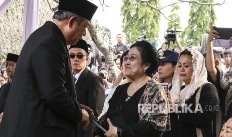 Presiden ke-6 Susilo Bambang Yudhoyono (kiri) berbincang dengan Presiden Ke-5 Megawati Soekarnoputri (kanan) saat menghadiri pemakaman ibu negara Ani Yudhoyono di Taman Makam Pahlawan Nasional Utama (TMP) Kalibata, Jakarta, Ahad (2/6/2019). 