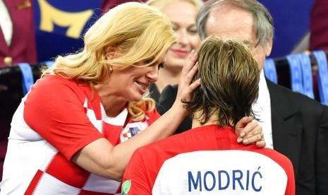 Presiden Kroasia Kolinda Grabar Kitarovic (kiri) saat menghibur kapten Kroasia, Luka Modric.