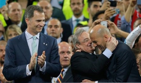 Presiden Real Madrid Florentino Perez memberi ucapan selamat kepada Pelatih Zinedine Zidane usai timnya berhasil meraih gelar juara Liga Champions di Stadion San Siro, Milan, Ahad (29/5). (AP/Manu Fernandez)