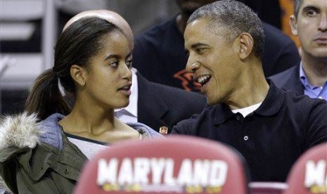 President Barack Obama as he chats with daughter Malia (file photo)