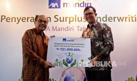 President Director of PT AXA Mandiri Financial Services, Jean Philippe Vandenschrick (kanan) melakukan serah terima kepada Ketua Umum Badan Amil Zakat Nasional (BAZNAS), Bambang Sudibyo (kiri) berupa Surplus Underwriting atau bagi hasil secara simbolik di 