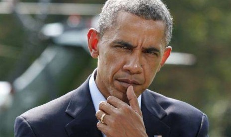 President Obama pauses as he speaks to the media on the situation in Iraq on the South Lawn of the White House, before his departure for vacation at Martha's Vineyard, in Washington August 9, 2014.