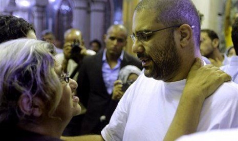 Prominent Egyptian blogger Alaa Abdel-Fattah hugs his mother, Laila Soueif, a university professor who is an also an activist, as he receives condolences for his father Ahmed Seif in Cairo, Egypt, Saturday, Aug. 30, 2014. 