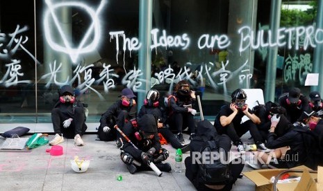 Mahasiswa beristirahat di area kampus Hong Kong Polytechnic University. Polisi mengepung kampus dengan ratusan mahasiswa pengunjukrasa di dalamnya.