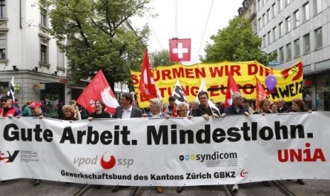 Protesters walk in downtown Zurich during a May Day demonstration May 1, 2014.