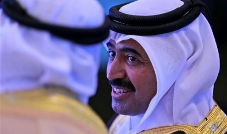 Qatar's Mohammed Bin Saleh Al-Sada, Minister of Energy and Industry speaks with his Saudi counterpart during the opening day of the 10th Arab energy Conference in Abu Dhabi, United Arab Emirates, Sunday, Dec. 21, 2014. 