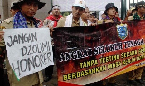   Ratusan massa yang tergabung dalam Forum Tenaga Honorer melakukan aksi unjuk rasa di depan Gedung DPR RI, Jakarta Pusat, Jumat (14/3). (Republika/Yasin Habibi)