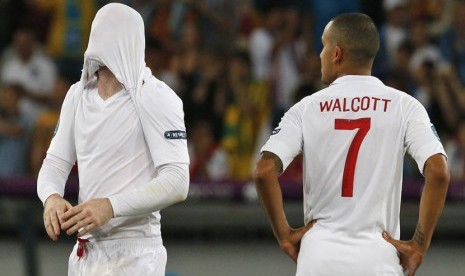  Reaksi pemain Inggris Wayne Rooney (kiri) dan Theo Walcott setelah gagal melaju ke semifinal di Olympic Stadium, Kiev, Senin (25/6) dini hari WIB. (Michael Sohn/Reuters) 