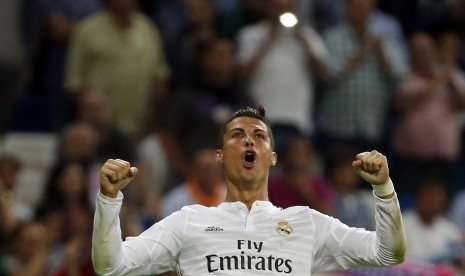 Real Madrid's Cristiano Ronaldo celebrates after scoring his fourth goal against Elche during their Spanish first division soccer match at Santiago Bernabeu stadium in Madrid September 23, 2014.