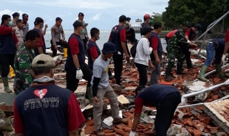 Relawan Artha Graha Peduli berkoordinasi dengan BNPB, Basarnas dan instansi pemerintah lainnya melakukan evakuasi korban dan membersihkan puing-puing di lokasi bencana tsunami Selat Sunda wilayah Carita, Banten, Rabu (26/12).