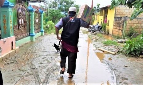 Relawan BMH menyusuri gang-gang di Sentani untuk menyalurkan bantuan berupa makanan cepat saji.