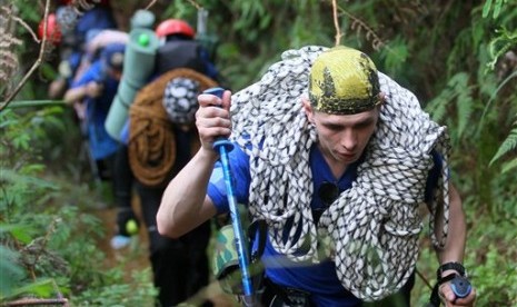 Rescuers from Russian ministry of emergency situation walk on the way to the crash site of the Sukhoi Superjet-100 at Mount Salak in Bogor, West Java, Indonesia, Sunday, May 13, 2012.   