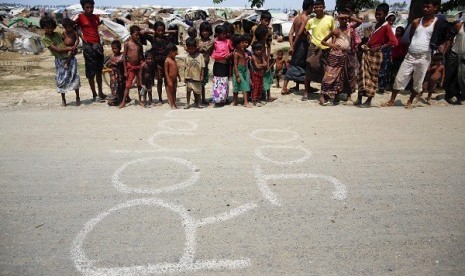 Rohingya Muslims stand beside the word 'refugee'. (Illustration)