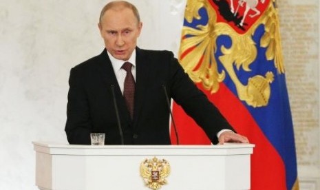 Russian President Vladimir Putin addresses the Federal Assembly, including State Duma deputies, members of the Federation Council, regional governors and civil society representatives, at the Kremlin in Moscow, March 18, 2014.