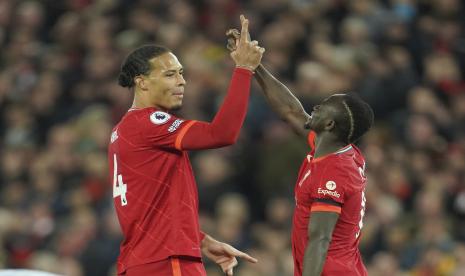 Sadio Mane dari Liverpool, kanan, merayakan setelah mencetak gol ketiga timnya dengan rekan setimnya Virgil van Dijk selama pertandingan sepak bola Liga Premier Inggris antara Liverpool dan Manchester United di stadion Anfield di Liverpool, Inggris, Selasa, 19 April 2022.