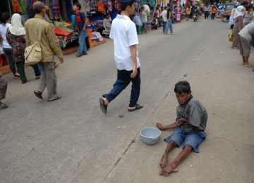 Salah seorang pengemis tengah mencari nafkah.