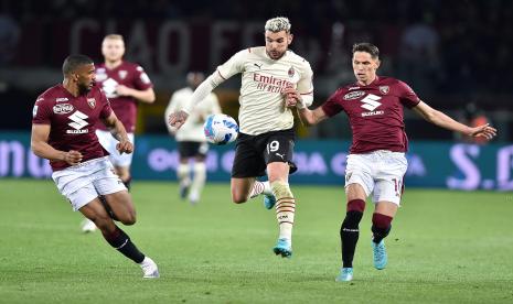 Sasa Lukic (kanan) dari Torino dan Theo Hernandez dari Milan (tengah) pada pertandingan sepak bola Liga Italia Serie A  di Stadion Olimpico Grande Torino di Turin, Italia, Senin (11/4/2022) dini hari WIB. 