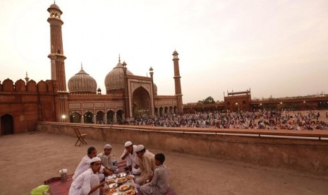 Satu keluarga menggelar tikar di atas ubin Masjid Jama di India untuk berbuka puasa.(thenational.ae)