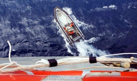 Sebah perahu dari kapal Angkatan Laut Australia HMAS Success, menyelidiki penampakan objek yang diduga berasal dari puing-puing di Samudera Hindia Selatan, Selasa (25/3).  (Reuters)