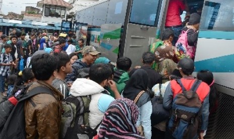 Sebuah bus jurusan Tasikmalaya diserbu para pemudik di Terminal Cicaheum, Kota Bandung, Senin (30/12). Menjelang tahun baru 2014, terminal bus dipenuhi masyarakat yang akan pulang kampung. 