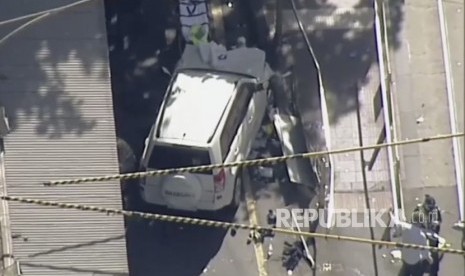 Sebuah kendaraan SUV putih dihentikan setelah diduga menabrak pejalan kaki di Melbourne, Australia, Kamis (21 /12).  