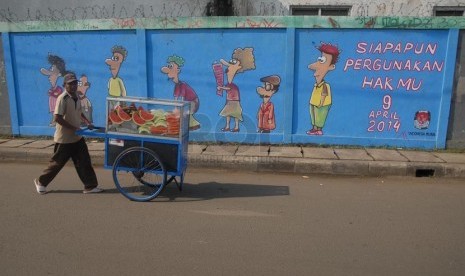 Sebuah mural bertemakan pemilu bertuliskan 