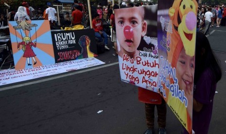 Sejumlah anak membentangkan poster 'Aku Ingin Dilindungi' pada anak saat aksi menentang kekerasan kepada anak di Jakarta, Ahad (2/11). 