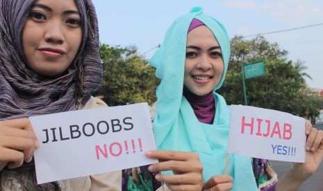  Sejumlah anggota komunitas Hijabers Tulungagung menunjukkan poster ajakan berhijab saat mengadakan aksi memperingati 