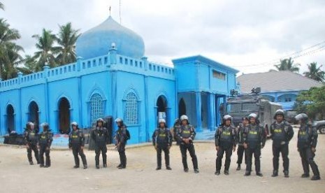 Sejumlah anggota polisi bersiaga menjaga kemaanan di depan Masjid Darus Sholihin di Puger, Jember, Jawa Timur, Kamis (12/9/2013).