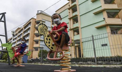 Sejumlah bocah dengan mengenakan masker bermain di Ruang Publik Terpadu Ramah Anak (RPTRA) Si Pitung, kawasan Rusunawa Marunda, Jakarta Utara. Saat ini di lingkungan tempat tinggal mereka sedang mengalami pencemaran lingkungan debu batu bara dalam bentuk flying ash bottom ash (FABA) atau debu yang terbawa angin berasal dari bongkar muat batu bara di Pelabuhan Marunda, Jakarta Utara. (ilustrasi)