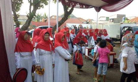 Sejumlah ibu rumah tangga dengan mengenakan gamis serba putih dan mengenakan kerudung merah siap menyambut Megawati dengan musik genjring, di TPS 027, Jalan Kebagusan IV, Jakarta Selatan, Rabu (19/4).