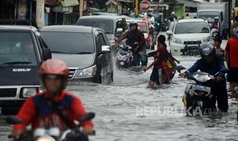 Sejumlah kendaraan mogok saat mencoba menerobos banjir di jalan raya Trosobo, Sidoarjo, Jawa Timur, Senin (10/10).