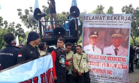 Sejumlah orang dari Koalisi Buruh Jakarta menggelar demonstrasi di depan Gedung Balai Kota DKI Jakarta, Selasa (31/10). Mereka menuntut UMP DKI Jakarta ditetapkan di angka Rp3,9 juta. 