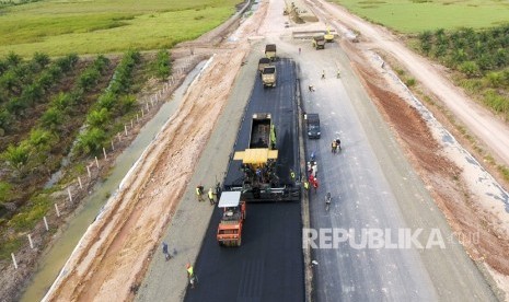 Sejumlah pekerja dengan alat berat melakukan pengaspalan jalan tol. (ilustrasi)