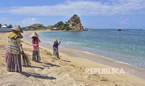 Sejumlah pekerja membersihkan pantai. (Ilustrasi)