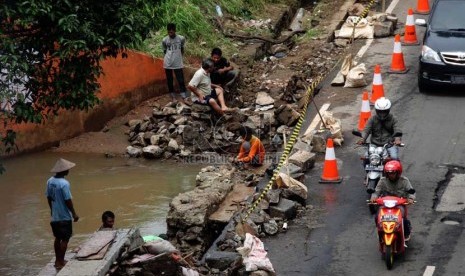 Pekerja memperbaiki jalan yang longsor akibat banjir di Jalan TB. Simatupang, Jakarta Selatan, Rabu (15/1).    (Republika/Yasin Habibi)