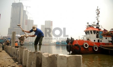 Sejumlah pekerja mengerjakan peninggian tanggul di Muara Angke, Jakarta Utara, Kamis (7/11). (Republika/Rakhmawaty La'lang)